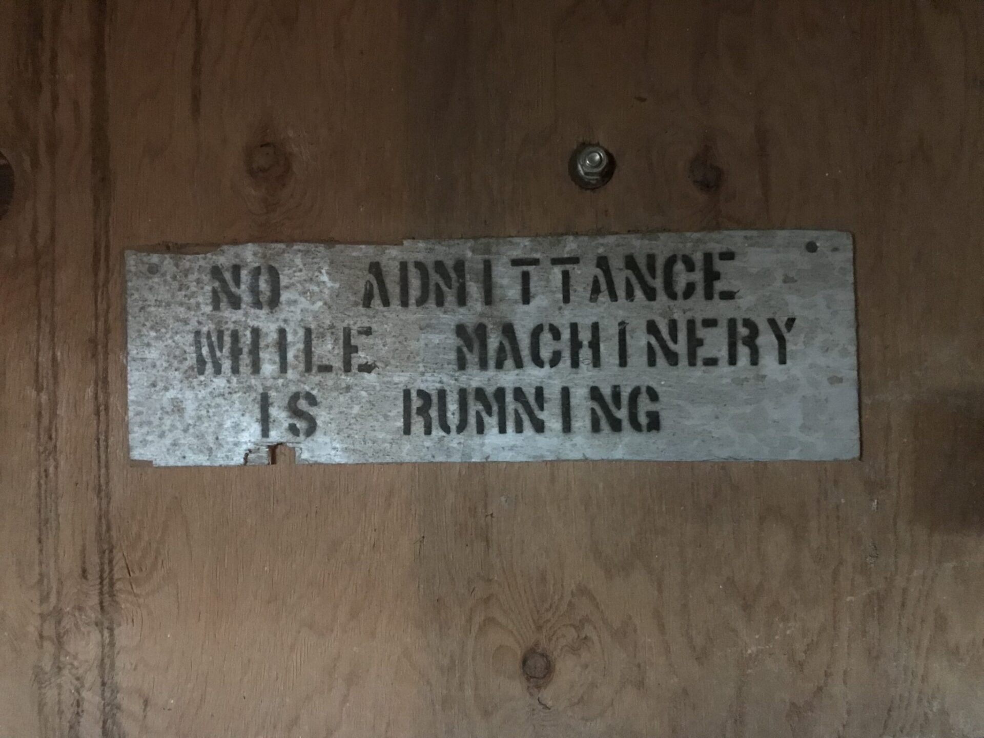 A sign reads "No admittance while machinery is running"