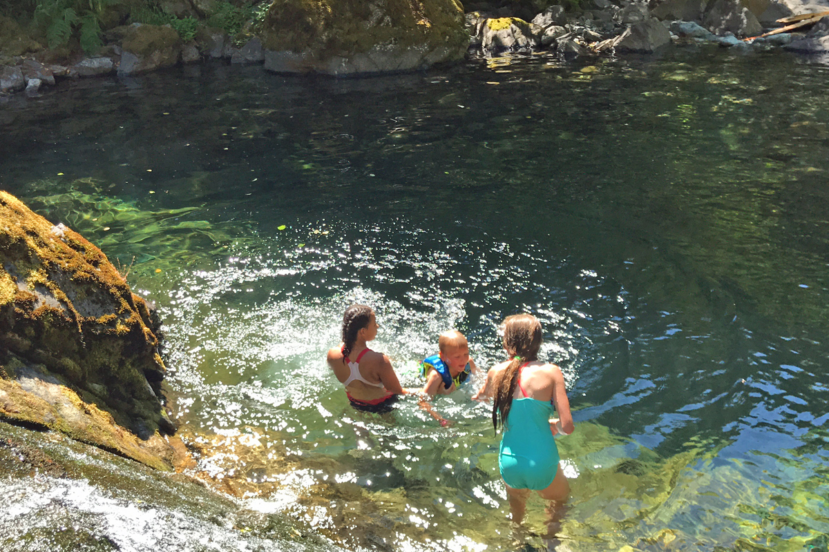 Three kids play in the Hobo Campground swimming hole.