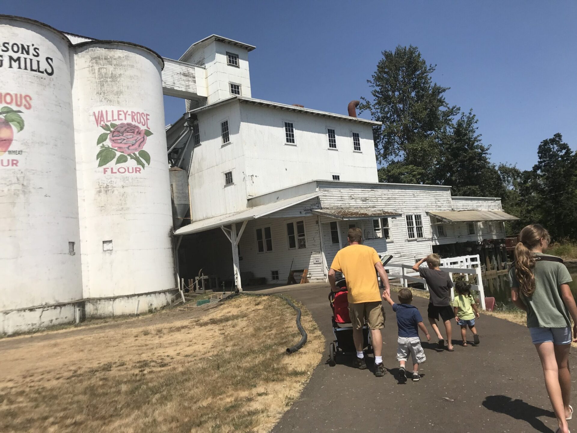 A family walks up the path to visit the Thompson Mill museum.