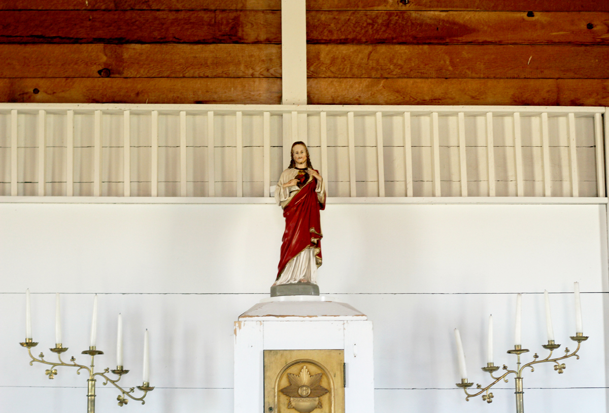 Inside the church at Homestead Village Museum in Fort Rock. Jesus, wrapped in red, stands atop an alter.