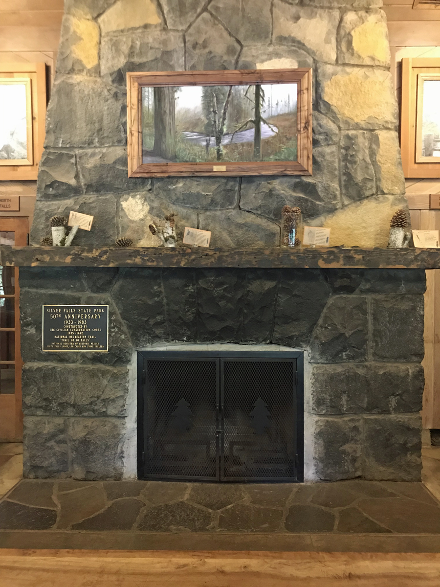 A fireplace made of stone inside the lodge.