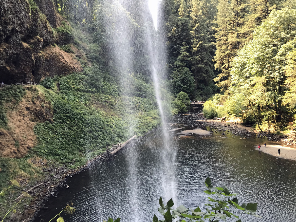 Water cascades down in front of us at South Falls. You can hike behind the waterfall and feel the mist.